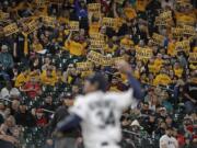 Fans in the “King’s Court” cheering section hold signs as Seattle Mariners starting pitcher Felix Hernandez throws during the fifth inning of a baseball game against the Los Angeles Angels, Monday, April 1, 2019, in Seattle. (AP Photo/Ted S.