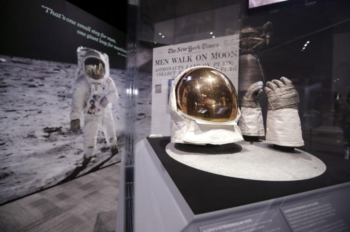 Buzz Aldrin’s outer visor and gloves worn while walking on the moon are displayed near a photo of Aldrin at “Destination Moon: The Apollo 11 Mission” exhibit at the Museum of Flight, Thursday in Seattle. The exhibit, opening Saturday, celebrates the 50th anniversary of the U.S. manned moon landing on July 20, 1969.