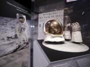 Buzz Aldrin’s outer visor and gloves worn while walking on the moon are displayed near a photo of Aldrin at “Destination Moon: The Apollo 11 Mission” exhibit at the Museum of Flight, Thursday in Seattle. The exhibit, opening Saturday, celebrates the 50th anniversary of the U.S. manned moon landing on July 20, 1969.