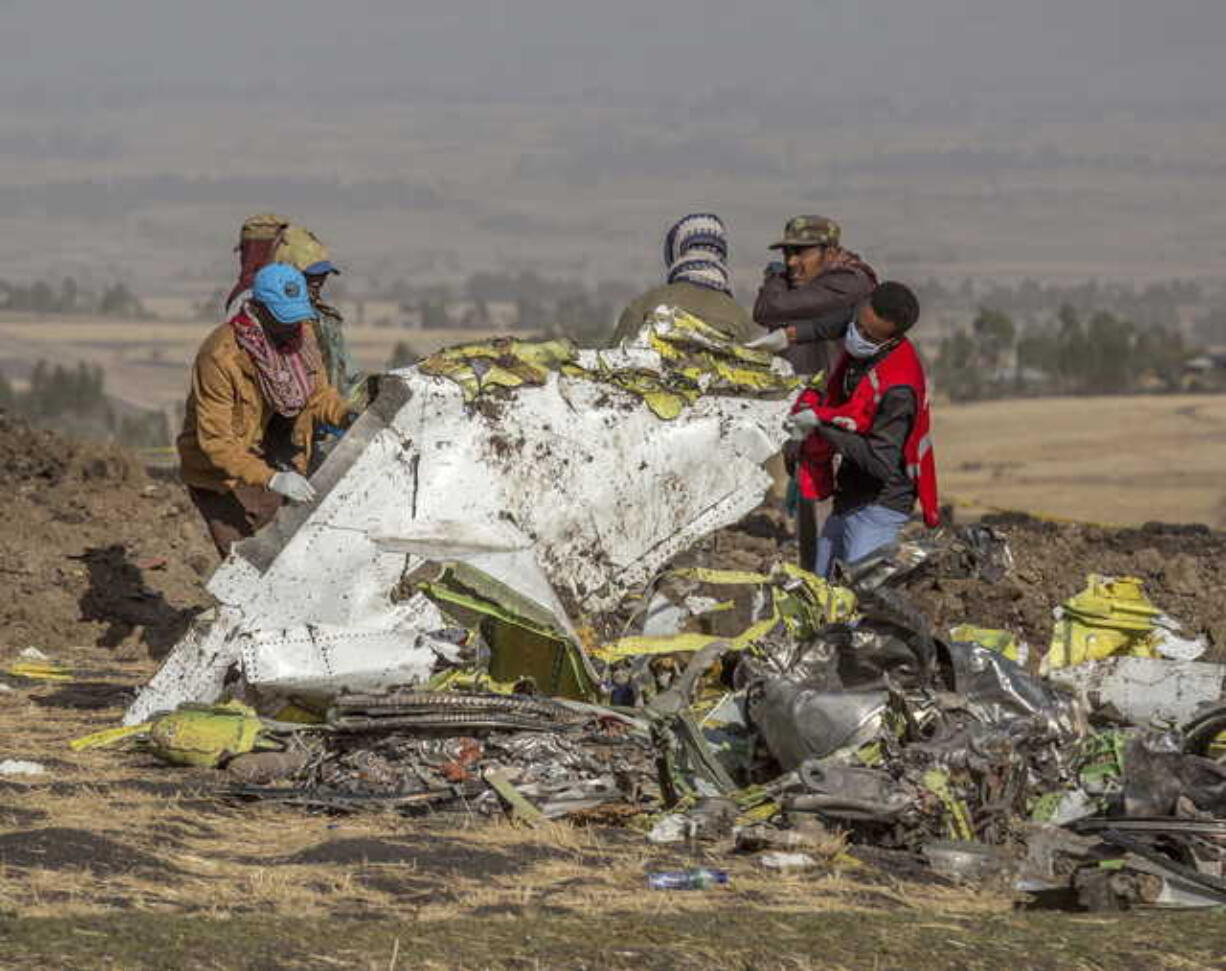 In this March 11, 2019, file photo, rescuers work at the scene of an Ethiopian Airlines flight crash near Bishoftu, Ethiopia. A published report says pilots of an Ethiopian airliner that crashed followed Boeing’s emergency steps for dealing with a sudden nose-down turn but couldn’t regain control.