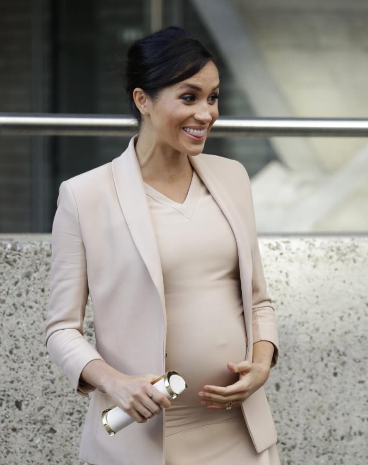 FILE - In this file photo dated Wednesday, Jan. 30, 2019, Britain’s Meghan, The Duchess of Sussex, leaves after visiting the National Theatre in London. Prince Harry and his pregnant wife Meghan, say they have decided to keep plans around their first baby’s arrival private, Kensington Palace officials said in a statement Thursday April 11, 2019.