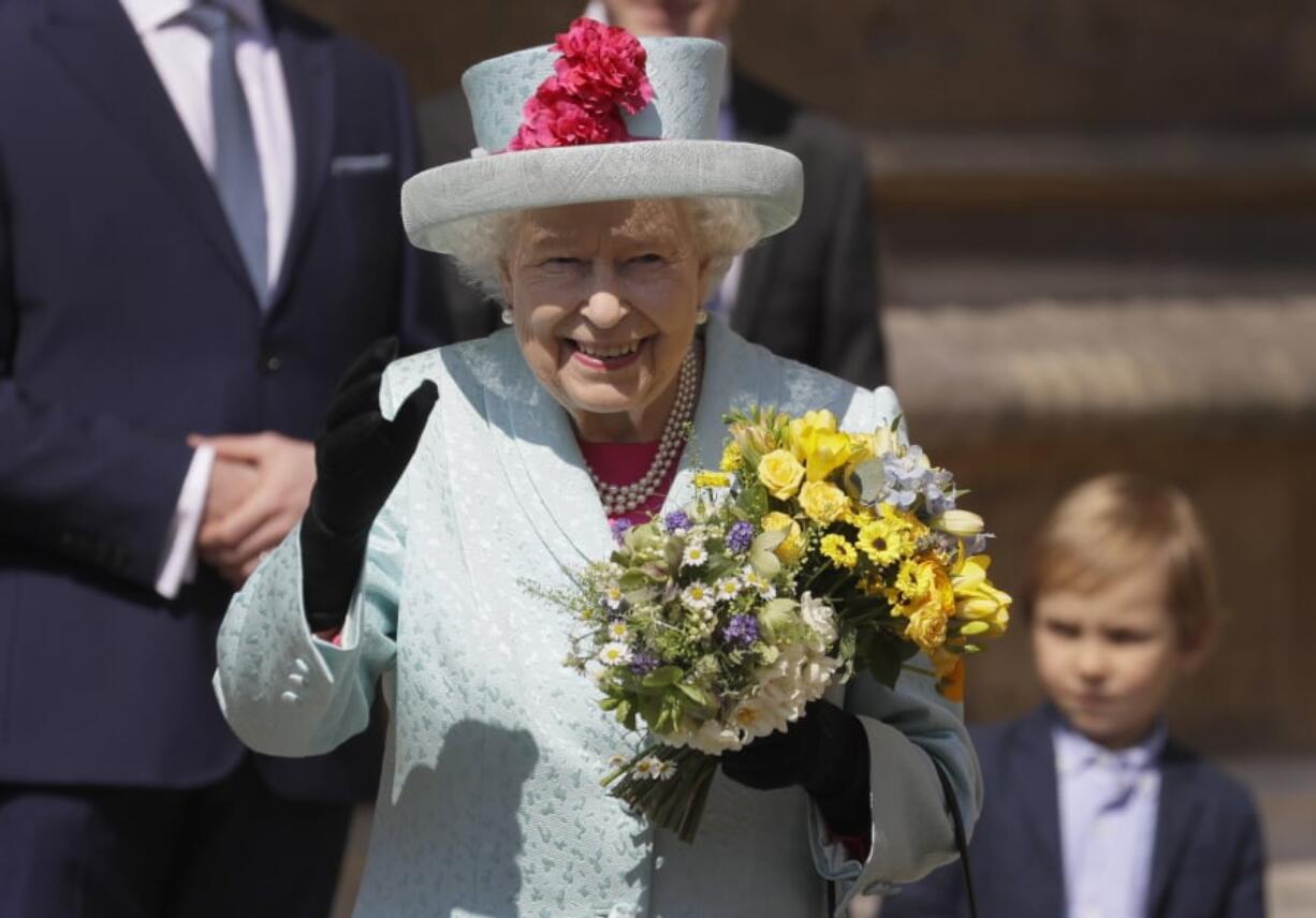 Britain’s Queen Elizabeth II waves to the public as she leaves after attending the Easter Mattins Service at St. George’s Chapel, at Windsor Castle in England Sunday.