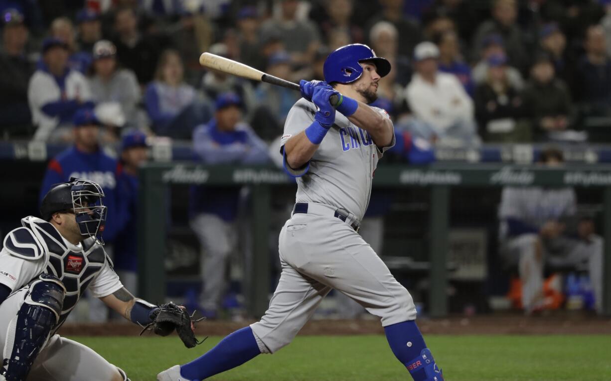 Chicago Cubs' Kyle Schwarber, right, and Seattle Mariners catcher Omar Narvaez watch the path of Schwarber's two-run home run in the eighth inning of a baseball game Tuesday, April 30, 2019, in Seattle.