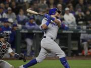 Chicago Cubs' Kyle Schwarber, right, and Seattle Mariners catcher Omar Narvaez watch the path of Schwarber's two-run home run in the eighth inning of a baseball game Tuesday, April 30, 2019, in Seattle.