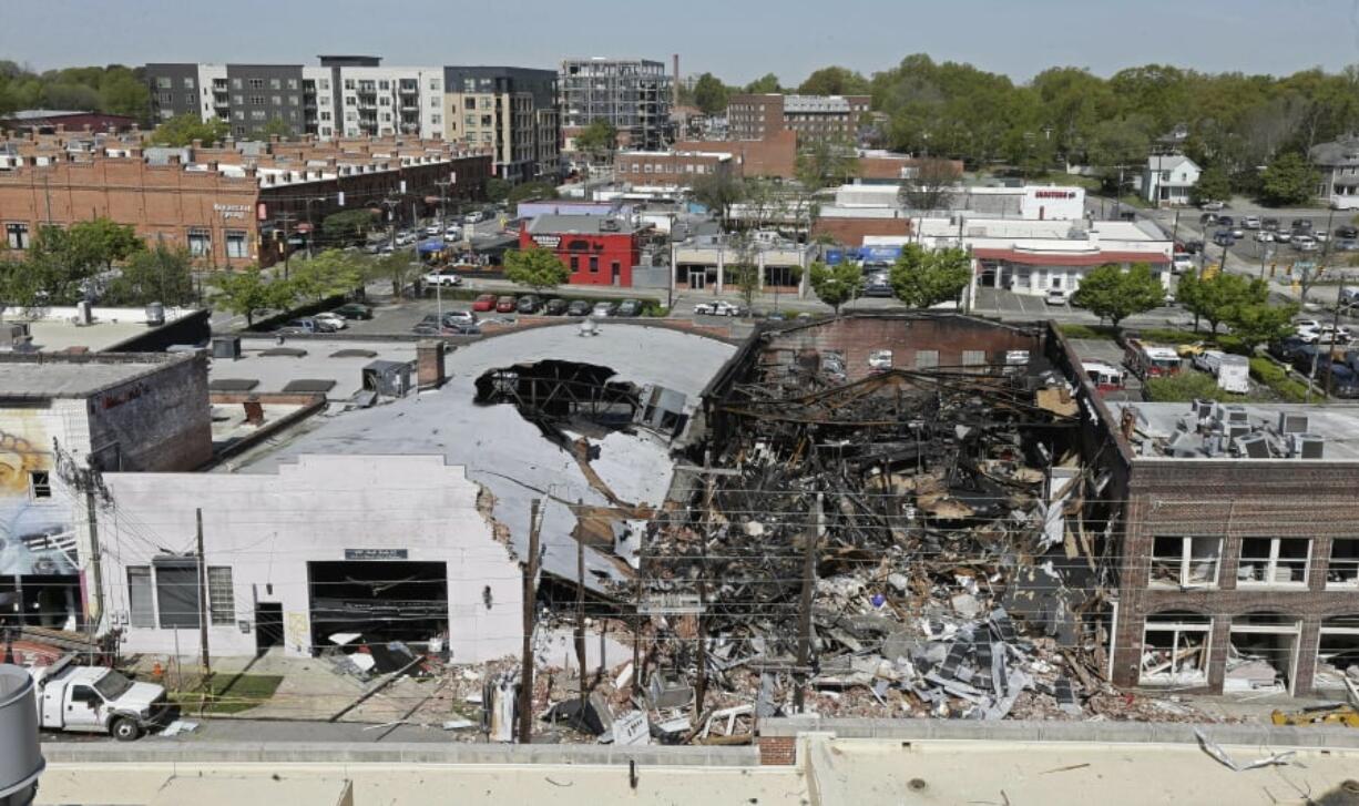 Charred remains are piled in a heap of rubble, Thursday, April 11, 2019, in Durham, N.C., the day after an explosion and building fire caused by a gas leak killed one person and injured more than two dozen, including nine firefighters.