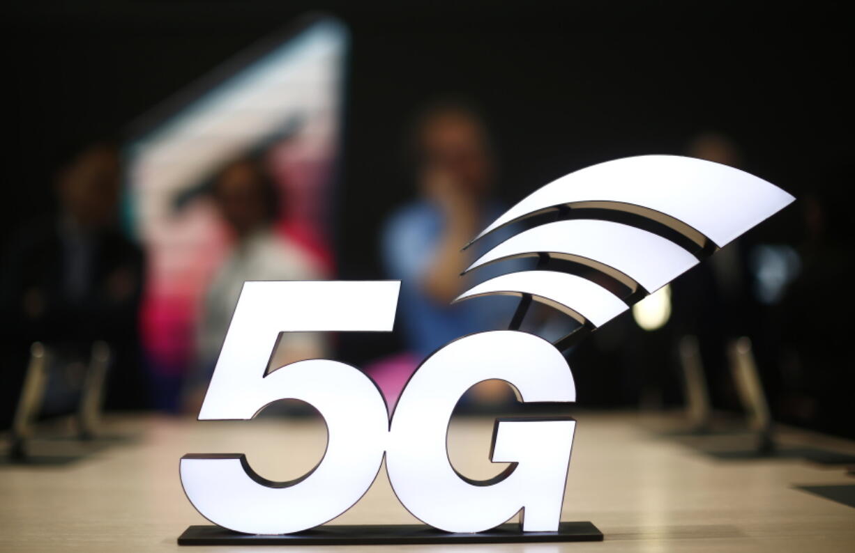 FILE - This Feb. 25, 2019 file photo shows a banner of the 5G network is displayed during the Mobile World Congress wireless show, in Barcelona, Spain. The U.S. communications regulator will hold a massive auction to bolster 5G service, the next generation of mobile networks, and will spend $20 billion for rural internet. 5G will mean faster wireless speeds and has implications for technologies like self-driving cars and augmented reality. The Federal Communications Commission said Friday, April 12, that it would hold the largest auction in U.S. history, of 3,400 megahertz, to boost wireless companies’ networks.