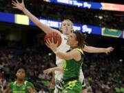 Oregon guard Sabrina Ionescu (20) drives to the basket as Baylor forward Lauren Cox (15), defends during a Final Four semifinal of the NCAA women’s college basketball tournament Friday, April 5, 2019, in Tampa, Fla.