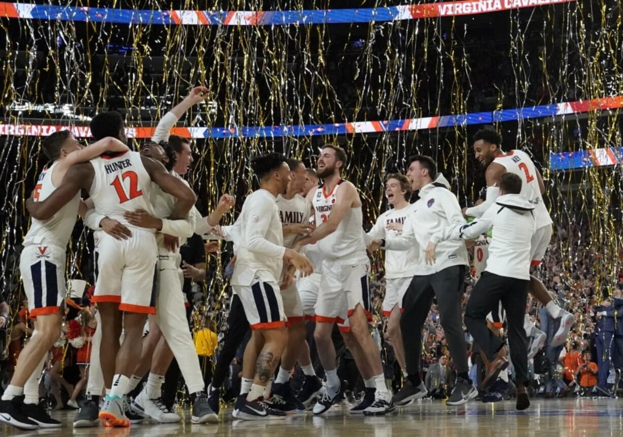 Virginia players celebrates after defeating Texas Tech 85-77 in the overtime in the championship of the Final Four NCAA college basketball tournament, Monday, April 8, 2019, in Minneapolis. (AP Photo/David J.