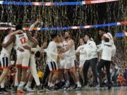 Virginia players celebrates after defeating Texas Tech 85-77 in the overtime in the championship of the Final Four NCAA college basketball tournament, Monday, April 8, 2019, in Minneapolis. (AP Photo/David J.