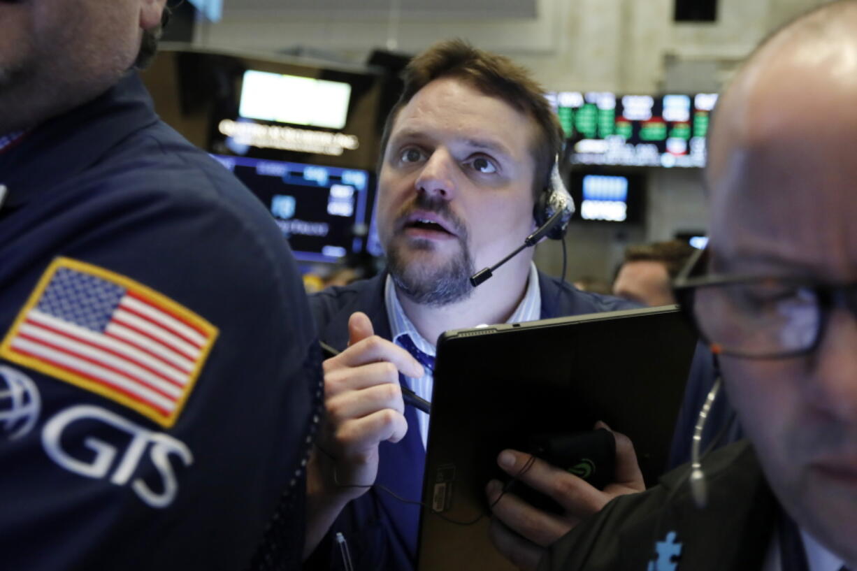 FILE - In this March 12, 2019, file photo, trader Michael Milano works on the floor of the New York Stock Exchange. The U.S. stock market opens at 9:30 a.m. EDT on Tuesday, April 23.