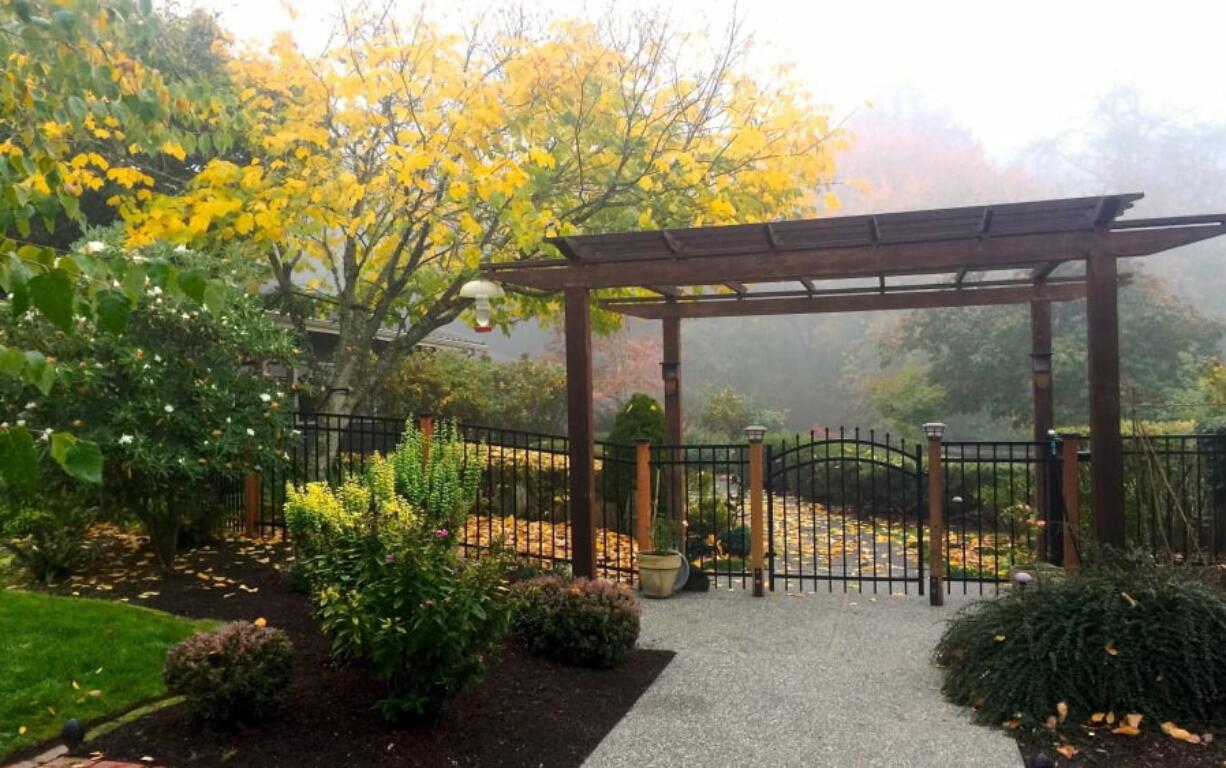 A pergola enhances a front entry at a home near Langley on Whidbey Island. Many of these structures are being upgraded with lighting and retractable shades to cover outdoor entertainment areas.