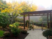 A pergola enhances a front entry at a home near Langley on Whidbey Island. Many of these structures are being upgraded with lighting and retractable shades to cover outdoor entertainment areas.