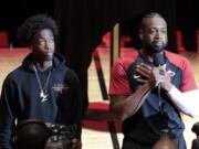 Miami Heat guard Dwyane Wade, right, speaks as his son Zaire, left, looks on during a ceremony honoring Wade who is playing his final home regular season game when the Heat host the Philadelphia 76ers, Tuesday, April 9, 2019, in Miami. Wade is retiring at the end of the season.