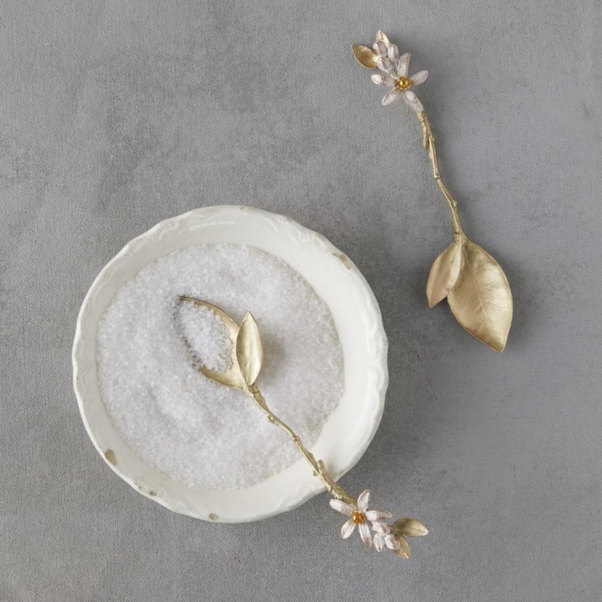 From left, Michael Michaud’s delicately crafted metal spoons; Lara Effron’s winsome watercolors adorn a cotton tea towel; and Michael Michaud’s delicately crafted metal napkin rings made using molds and natural botanical material.