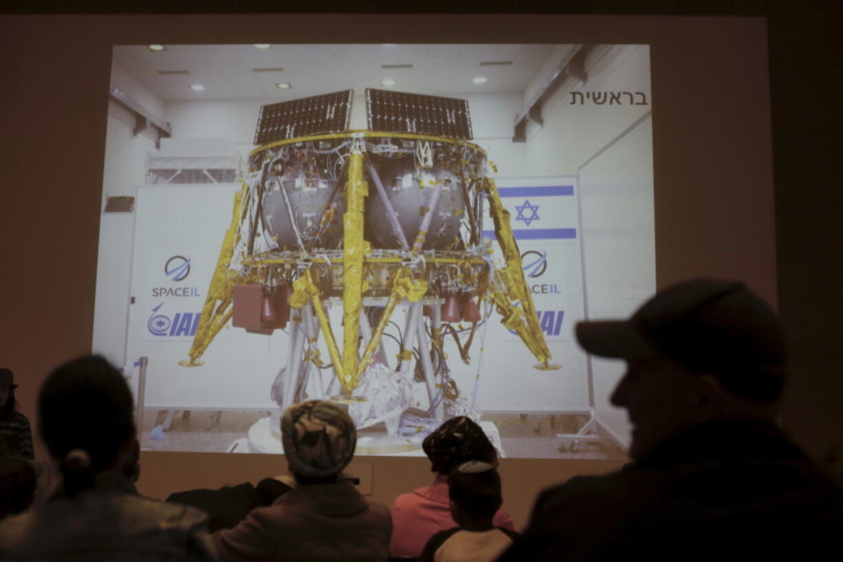 People watch the live broadcast of the SpaceIL spacecraft as it lost contact with Earth in Netanya, Israel, Thursday, April 11, 2019.