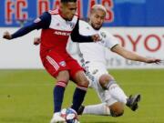 FC Dallas forward Jesus Ferreira, left, shoots for the first goal of the game as he is defended by Portland Timbers defender Bill Tuiloma (25) during the first half of an MLS soccer match in Frisco, Texas, Saturday, April 13, 2019. (Stewart F.