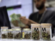 FILE - In this July 1, 2017, file photo, a cashier rings up a marijuana sale at the Essence cannabis dispensary in Las Vegas. Complaints that the state releases no information about who applies for and receives dispensary licenses in Nevada’s booming retail marijuana business are spurring lawsuits and legislative proposals that appear poised to push the process public.