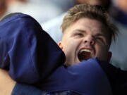 Seattle Mariners designated hitter Daniel Vogelbach hugs a teammate while celebrating in the dugout after hitting a solo home run during the 10th inning of a baseball game against the Kansas City Royals at Kauffman Stadium in Kansas City, Mo., Thursday, April 11, 2019. The Mariners defeated the Royals 7-6 in 10 innings.