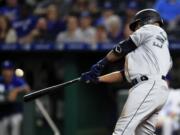 Seattle Mariners first baseman Edwin Encarnacion hits a three-run home run off Kansas City Royals relief pitcher Kevin McCarthy during the sixth inning of a baseball game at Kauffman Stadium in Kansas City, Mo., Monday, April 8, 2019. It was the second home run of the inning for Encarnacion.