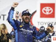 Martin Truex Jr. celebrates in Victory Lane after winning the NASCAR Cup Series auto race at Richmond Raceway in Richmond, Va., Saturday, April 13, 2019.