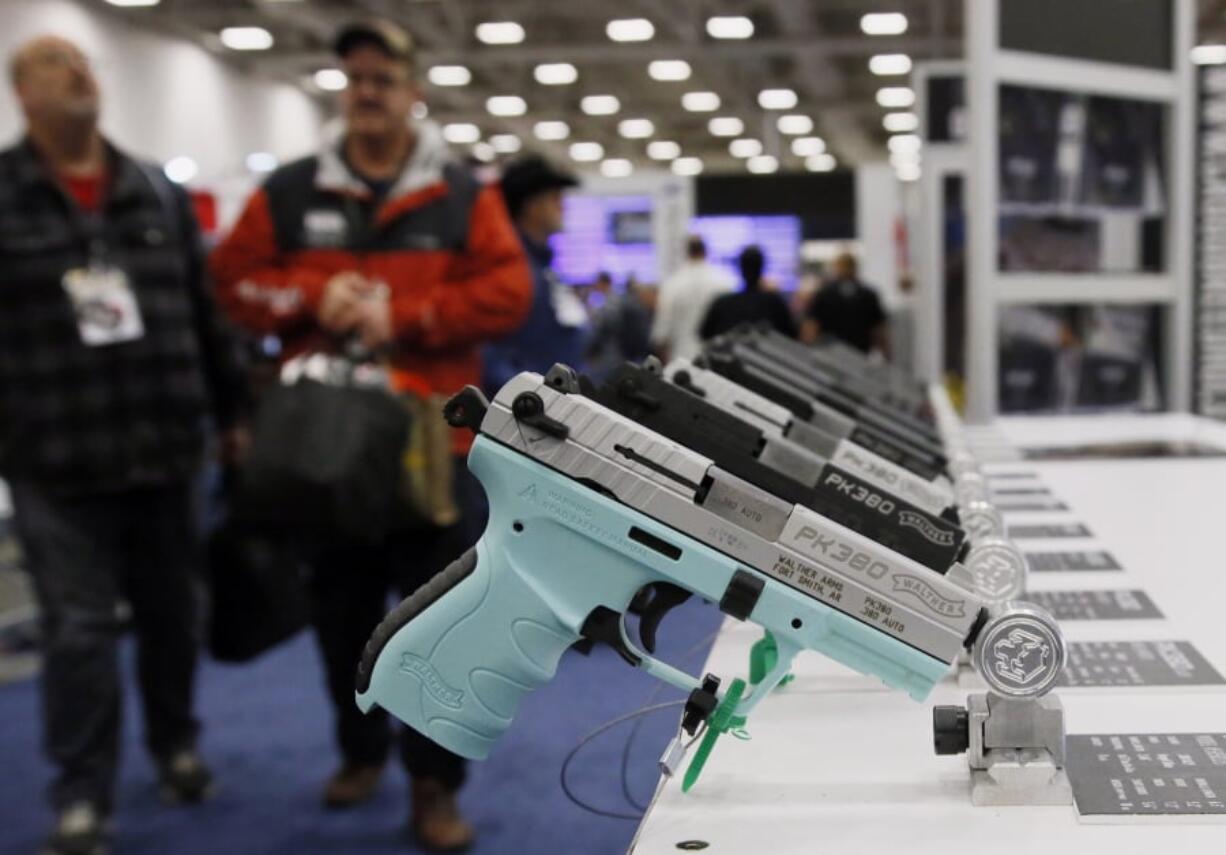 FILE - In this May 4, 2018, file photo, handguns are on display at the NRA convention in Dallas. The National Rifle Association is gathering for its 148th annual meeting beginning Thursday, April 25, 2019, in Indianapolis.