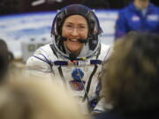 FILE - In this Thursday, March 14, 2019 file photo, U.S. astronaut Christina Koch, member of the main crew of the expedition to the International Space Station (ISS), speaks with her relatives through a safety glass prior the launch of Soyuz MS-12 space ship at the Russian leased Baikonur cosmodrome, Kazakhstan. Koch will remain on board until February, approaching but not quite breaking Scott Kelly’s 340-day U.S. record.