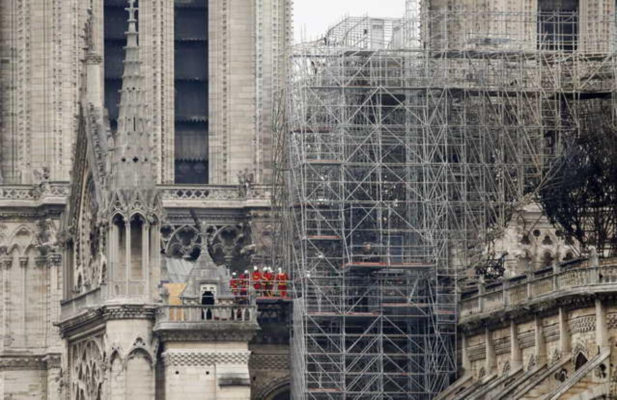 Firemen inspect the Notre Dame cathedral after the fire in Paris, Tuesday, April 16, 2019. Experts are assessing the blackened shell of Paris' iconic Notre Dame cathedral to establish next steps to save what remains after a devastating fire destroyed much of the almost 900-year-old building. With the fire that broke out Monday evening and quickly consumed the cathedral now under control, attention is turning to ensuring the structural integrity of the remaining building.