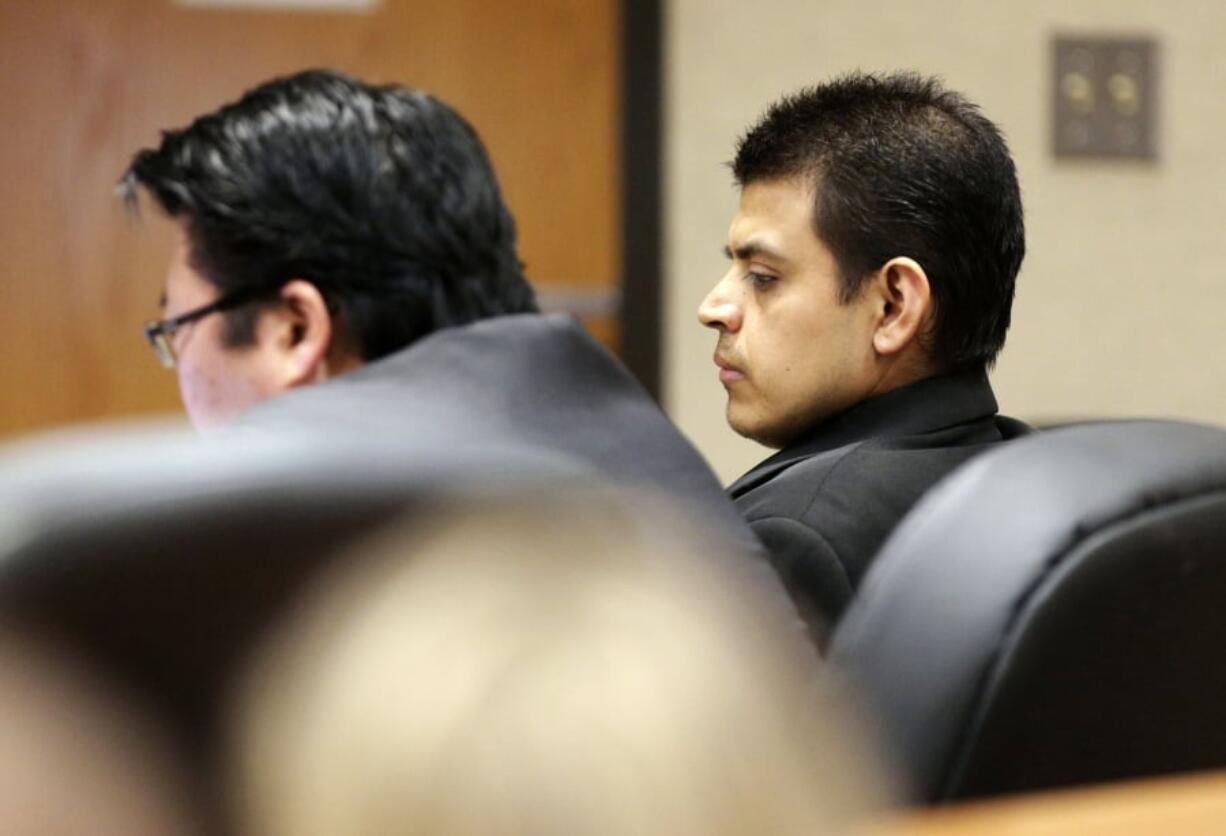 FILE - In this March 23, 2017, file photo, Edwin Lara sits with his defense team during a hearing in a courtroom at the Deschutes County Circuit Court in Bend, Ore. A judge has given the former college campus security officer a federal life sentence for terrorizing a 19-year-old woman by carjacking her at gunpoint in Oregon and forcing her to accompany him to California after having killed another woman. The Oregonian/OregonLive reports U.S. District Judge Michael J.