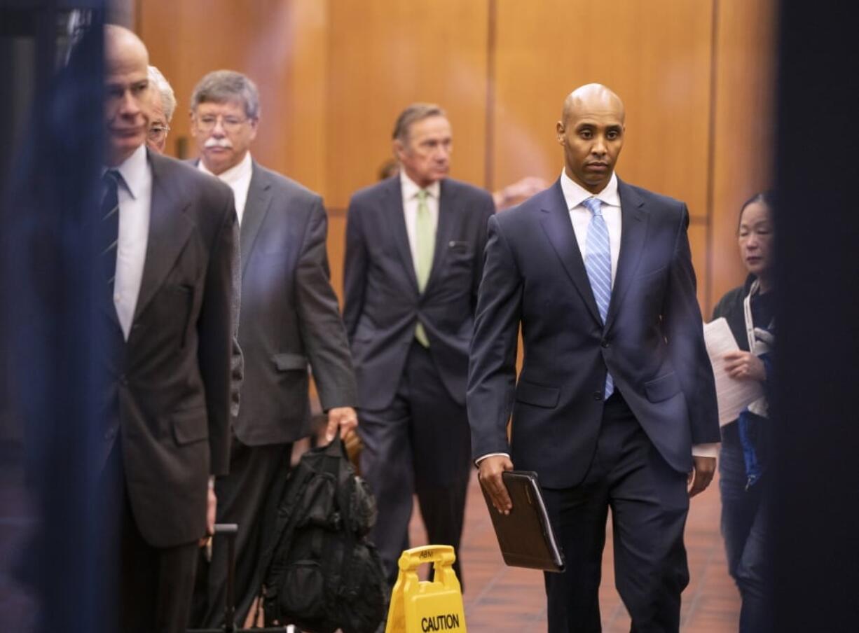 Former Minneapolis police officer Mohamed Noor walks through the elevator lobby of the Hennepin County Government Center with his legal team in Minneapolis on Friday, April 26, 2019.