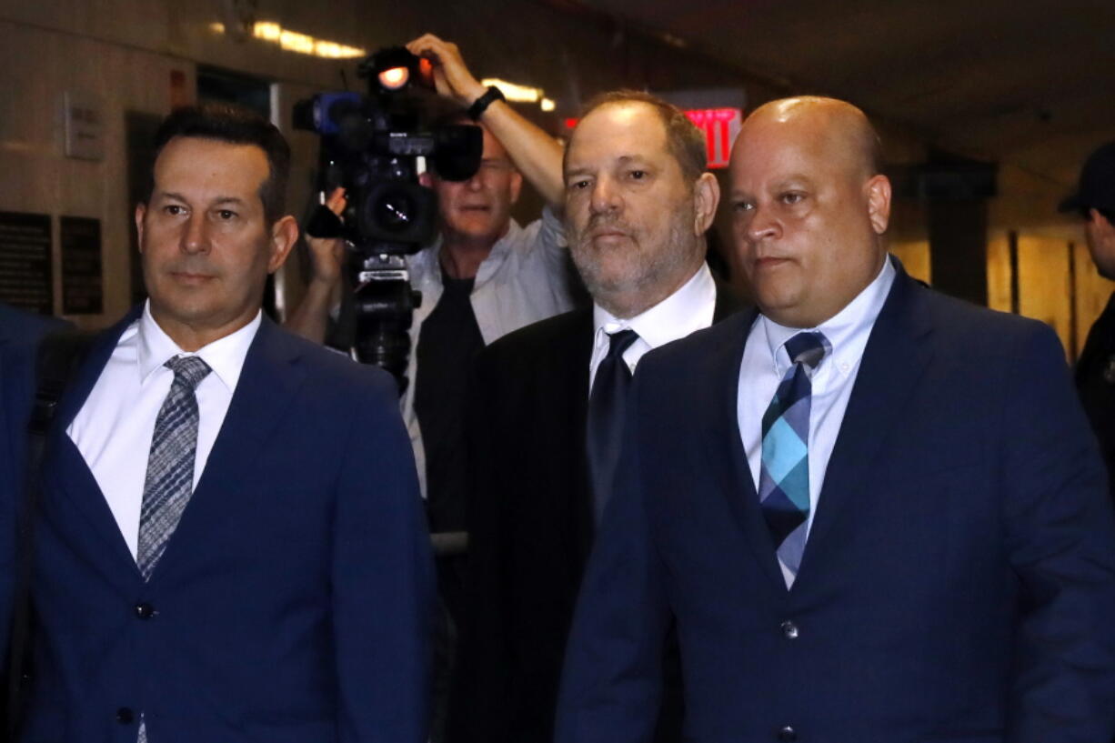 Harvey Weinstein, second from right, enters State Supreme Court in New York, Friday, April 26, 2019. Both sides in Harvey Weinstein’s sexual assault case want the media and the public barred from the disgraced movie mogul’s court appearance.