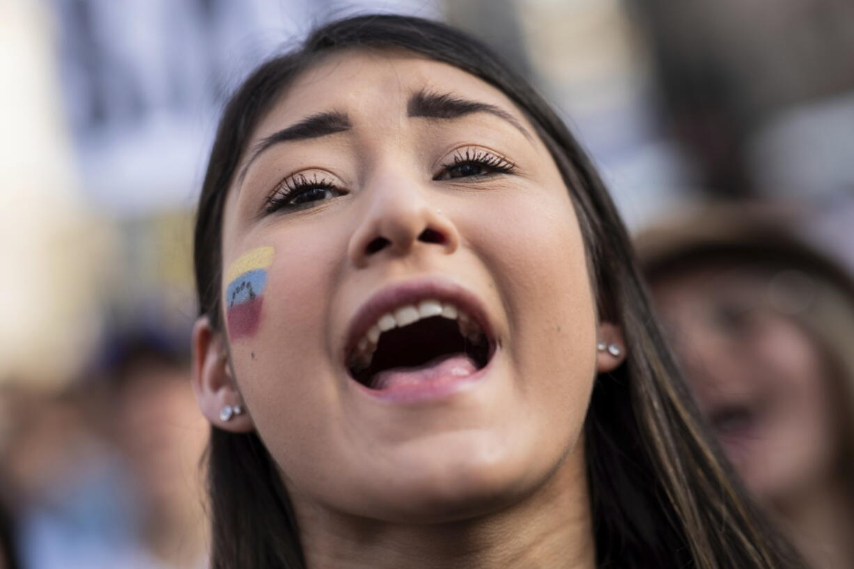 A Venezuelan woman shouts slogans in favor of Venezuelan opposition leader Juan Guaido on Tuesday in Madrid, Spain.