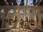 In this Thursday, April 25, 2019 photo, sunlight steams in from gaping holes, as a surveyor works at St. Sebastian’s Church, where a suicide bomber blew himself up on Easter Sunday in Negombo, north of Colombo, Sri Lanka. Nearly a week later, the smell of death is everywhere, though the bodies are long gone. Yet somehow, there’s a beauty to St. Sebastian’s, a neighborhood church in a Catholic enclave north of Sri Lanka’s capital. You can see the beauty in the broken stained-glass windows. It’s there in the little statues that refused to fall over, and despite the swarms of police and soldiers who seem to be everywhere now in the streets of the seaside town of Negombo.