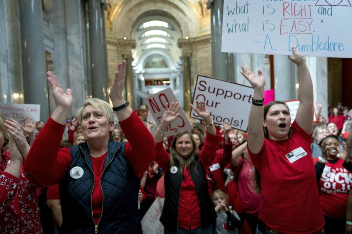 FILE - In this March 12, 2019 file photo, a group of the several hundred teachers gather to protest perceived attacks on public education at the Capitol, in Frankfort, Ky. Kentucky’s attorney general filed a lawsuit Monday, April 29 to try to block subpoenas issued by Gov. Matt Bevin’s administration as part of an investigation of teachers who might have used sick days that shut down schools as they attended statehouse rallies.