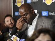 Magic Johnson wipes his eyes as he speaks to reporters prior to an NBA basketball game between the Los Angeles Lakers and the Portland Trail Blazers on Tuesday, April 9, 2019, in Los Angeles. Johnson abruptly quit as the Lakers' president of basketball operations Tuesday night, citing his desire to return to the simpler life he enjoyed as a wealthy businessman and beloved former player before taking charge of the franchise just over two years ago. (AP Photo/Mark J.