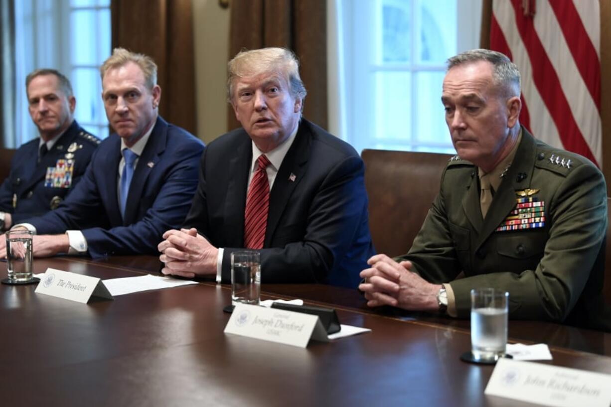 President Donald Trump, second from right, flanked by acting Defense Secretary Patrick Shanahan, second from left, and Chairman of the Joint Chiefs of Staff Gen. Joseph Dunford, right, speaks during a meeting with military leaders in the Cabinet Room of the White House in Washington, Wednesday, April 3, 2019. At left is Air Force Chief of Staff Gen. David Goldfein.