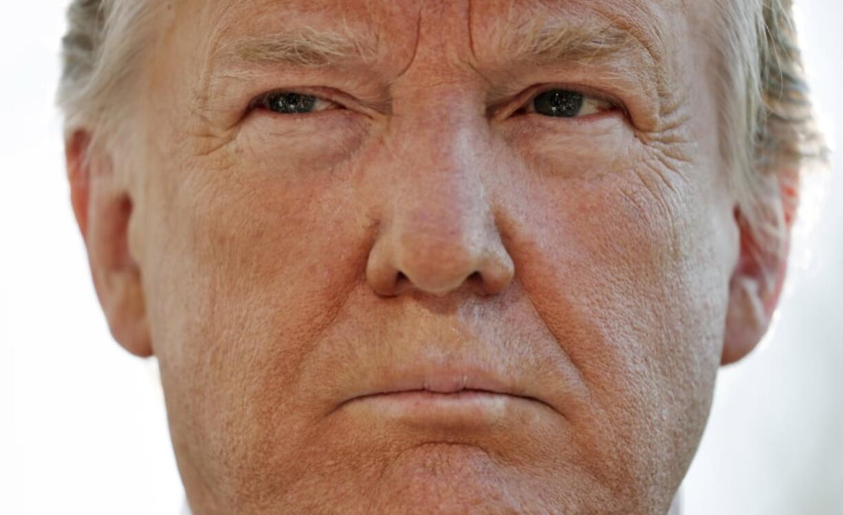 President Donald Trump pauses while speakings to members of the media on the South Lawn of the White House in Washington, before boarding Marine One helicopter, Wednesday, April 10, 2019.