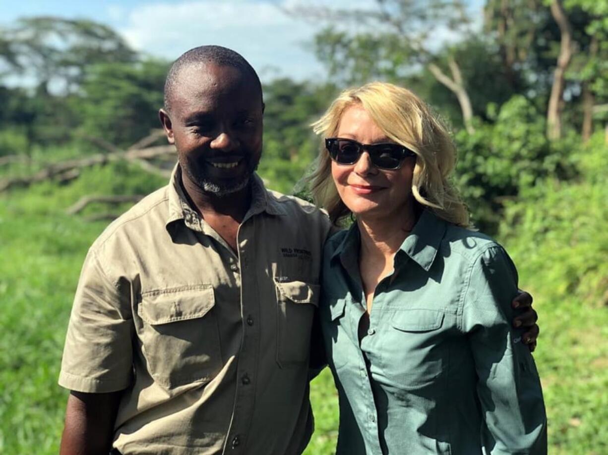 Image released by Wild Frontiers tour company on Monday April 8, 2019, shows American tourist Kim Endicott, right, and field guide Jean-Paul Mirenge a day after they were rescued following a kidnap by unknown gunmen in Uganda’s Queen Elizabeth National Park. Ugandan police said on Sunday they had rescued Endicott, an American tourist, and her guide, Mirenge, who had been kidnapped by gunmen in a national park.