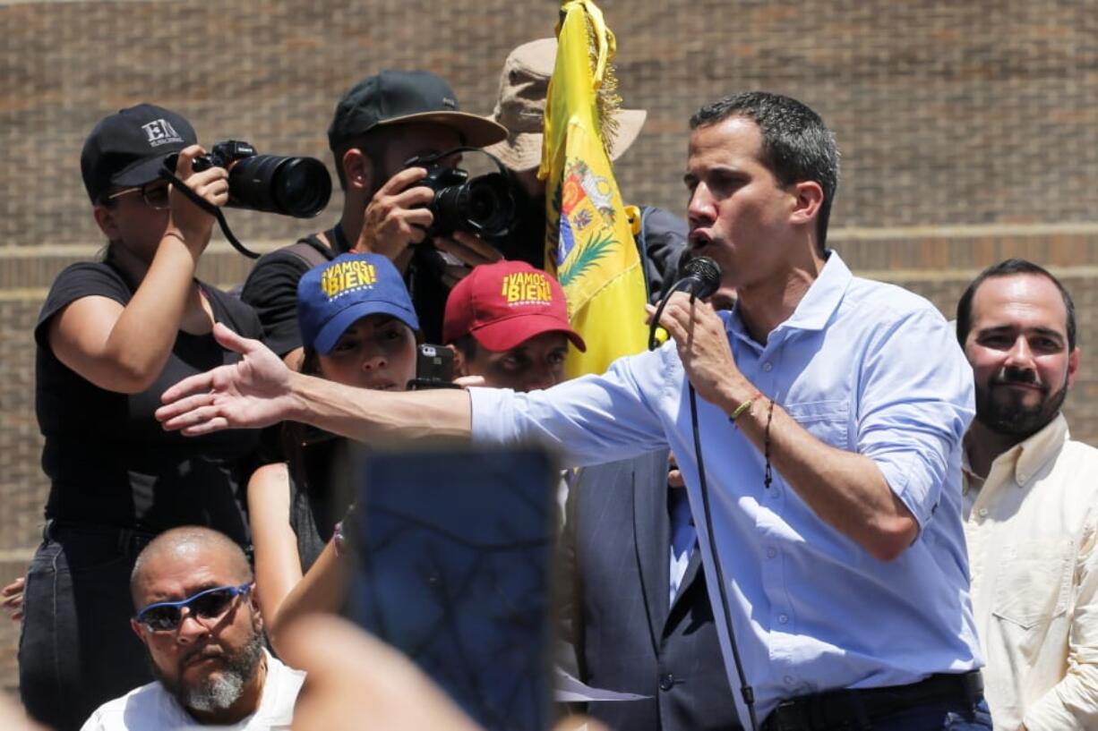 Opposition leader and self-proclaimed interim president Juan Guaido speaks to supporters during a rally to protest outages that left most of the country scrambling for days in the dark in Caracas, Venezuela, Saturday, April 6, 2019.