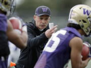 Washington head coach Chris Petersen talks to players as they run drill during the first day of spring NCAA college football practice, Wednesday, April 3, 2019, in Seattle. (AP Photo/Ted S.