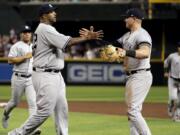 New York Yankees starting pitcher CC Sabathia, left, celebrates with first baseman Luke Voit after throwing his 3,000th career strikeout, during the second inning of the team’s baseball game against the Arizona Diamondbacks, Tuesday, April 30, 2019, in Phoenix.