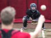 LEAD OPTION-Grant Heiser keeps his eyes on a pitch during a catching drill at Camas High School on Thursday afternoon, May 16, 2019.