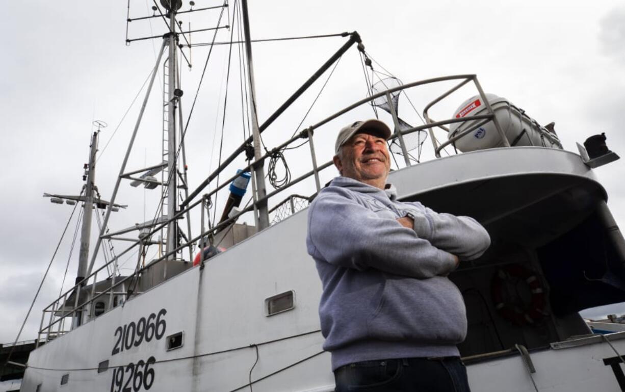 Wade Bassi, skipper and co-owner of the 106-year-old halibut fishing vessel Polaris, stands near his boat, moored April 11 at Fisherman’s Terminal in Seattle. ELLEN M.