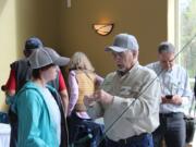 Clark-Skamania Flyfishers member Gene Reinert works with a student to assemble fly fishing gear. The beginners class is a way for people interested in fly fishing to learn about the gear, techniques, and ethics of the sport.