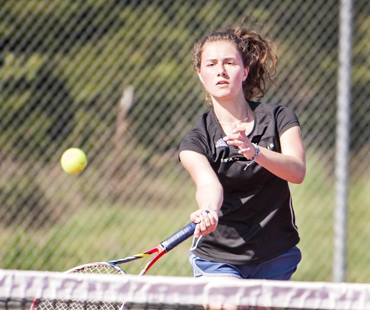 Union junior Miriam Muntean drops in a shot against Camas sophomore Rachel Merrill in a 6-1, 6-2 victory at No. 1 singles in a dual match Wednesday in Camas. Muntean will pair with Nicole Knudtson in hopes of making a deep postseason run for the Titans.