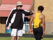 Hudson's Bay boys track and field coach Tom Petersen offers instruction to high jumper Jaden Lewis during a meet at Mountain View High School.