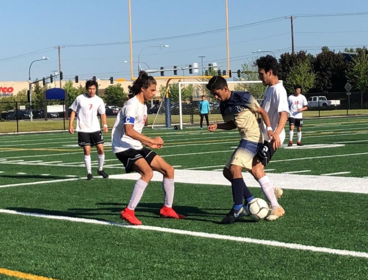 Seton Catholic forward Jetszael Meza-Gonzalez tries to fend off two Columbia-White Salmon defenders during a 1A district playoff match Friday at Seton Catholic.