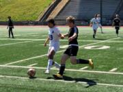 Mountain View midfielder Elijah Thompson (19) battles for the ball with Prairie midfielder Thomas Scruggs during a 3A bi-district soccer match on Saturday at McKenzie Stadium.