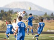 Ridgefield’s Sebastian Interian (1) and Aberdeen’s Rigo Alavez (2) battle for a header in front Mount St. Helens in a 2A district playoff game Saturday at Ridgefield. Aberdeen won 2-1.