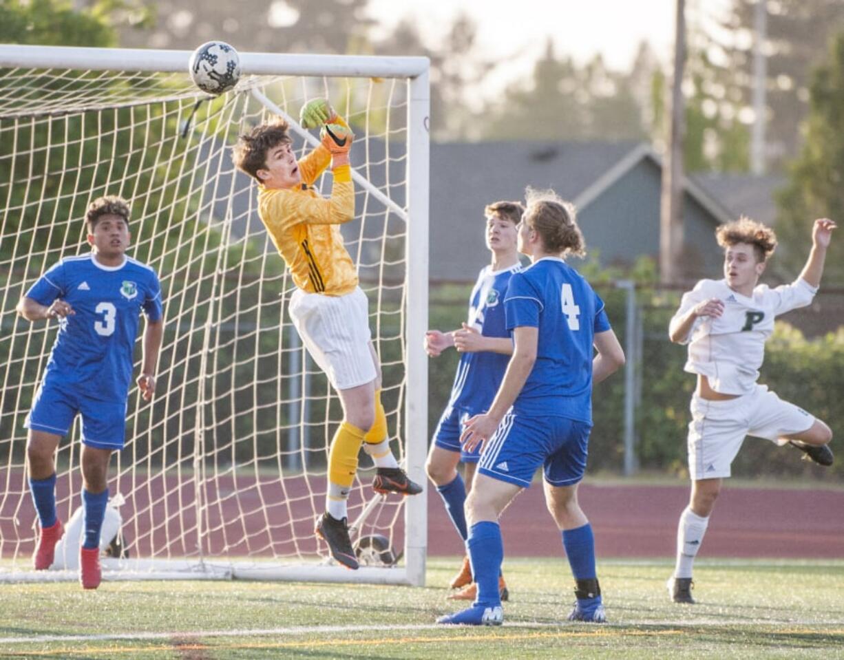 Mountain View goalkeeper Cole Taylor punches a cross away in a 3A bi-district boys soccer game against Peninsula. Taylor stopped four shots during a shootout in Mountain View’s first-round state victory over Hermiston on Tuesday.