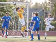 Mountain View goalkeeper Cole Taylor punches a cross away in a 3A bi-district boys soccer game against Peninsula. Taylor stopped four shots during a shootout in Mountain View’s first-round state victory over Hermiston on Tuesday.